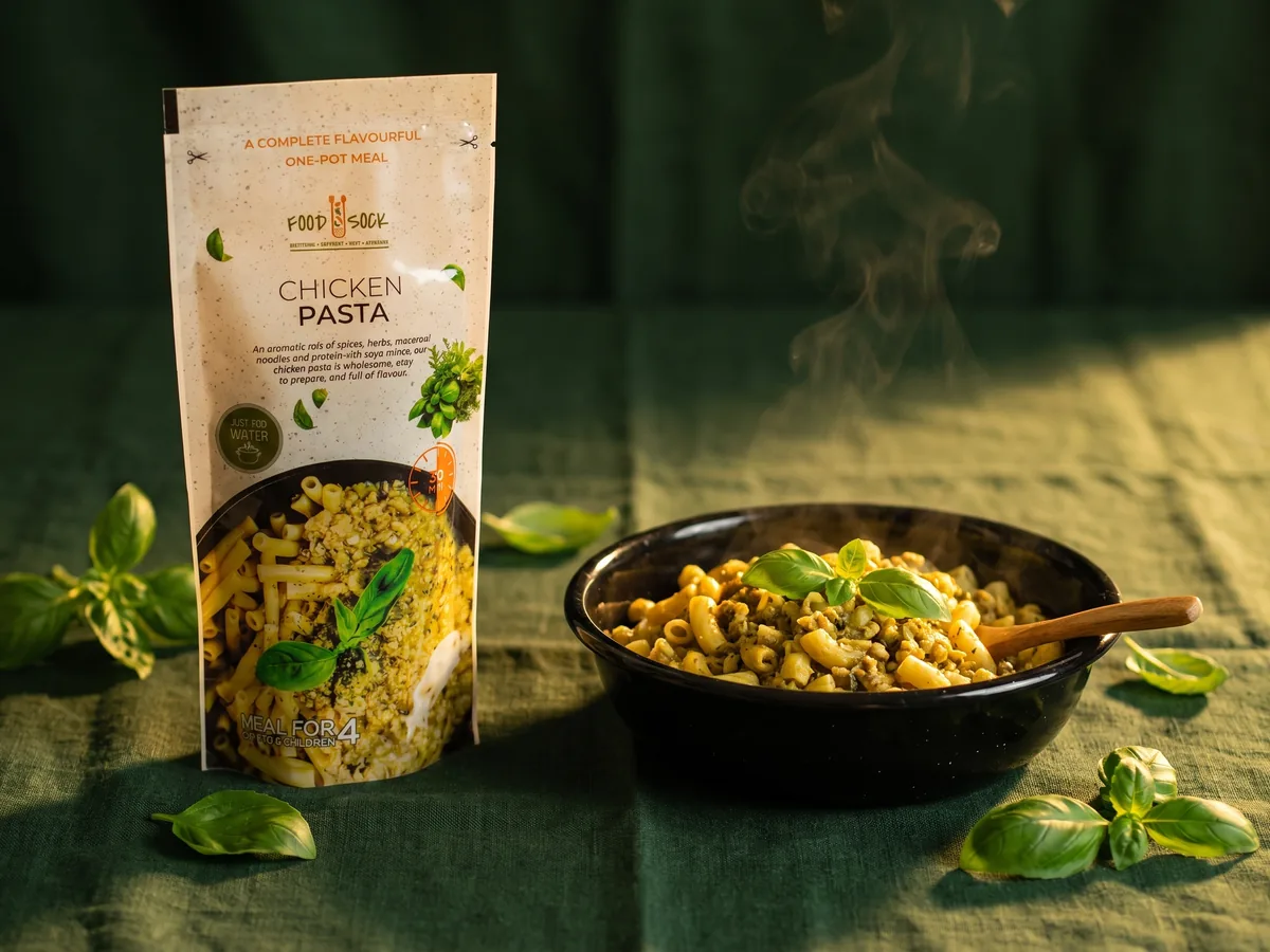 Illustration: a Food Sock meal pouch beside a bowl of the cooked one-pot meal